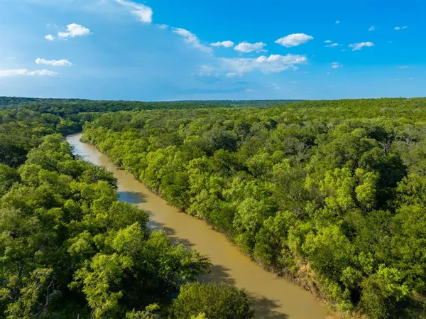 a view of a field with an ocean