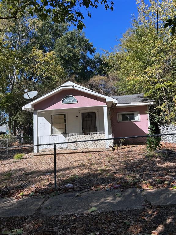 Bungalow-style house with a fenced front yard and a porch