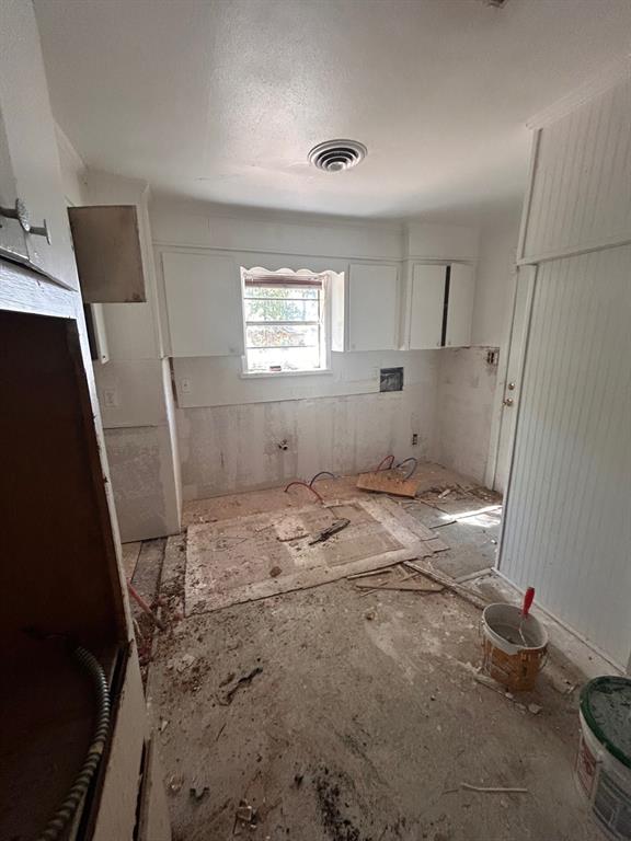 2606 Merwin Street Shreveport, LA 71103 - Photo 5 of 6 Kitchen with white cabinetry and a textured ceiling