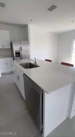 a view of an empty room with a fireplace and a bathroom