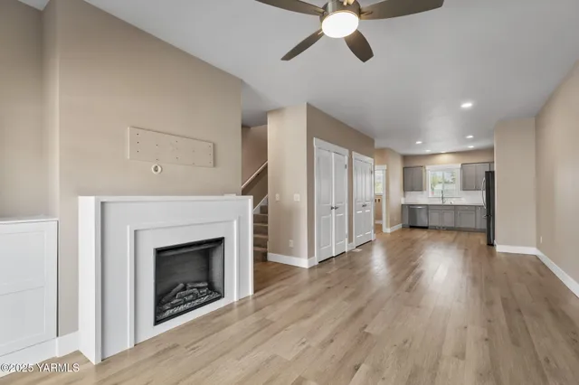 a view of an empty room with a fireplace and a window