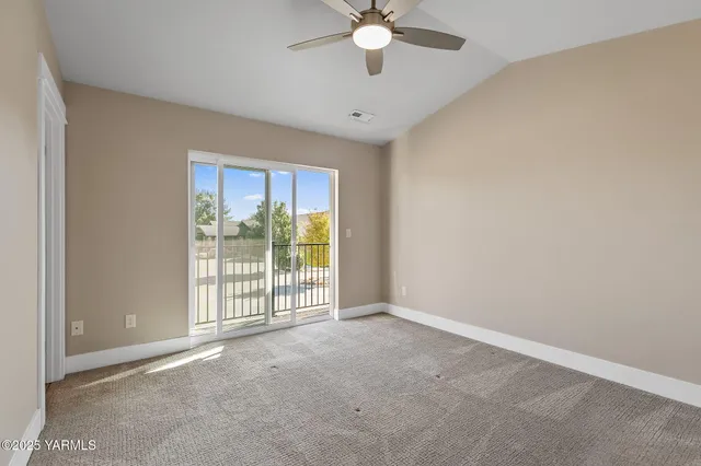 a view of a livingroom with a ceiling fan and window