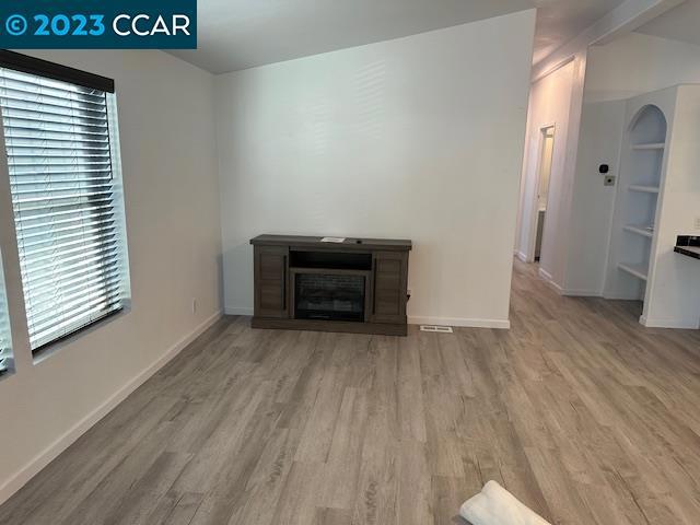265 Carob Way Pacheco, CA 94553 - Photo 5 of 16 an empty room with wooden floor and a window