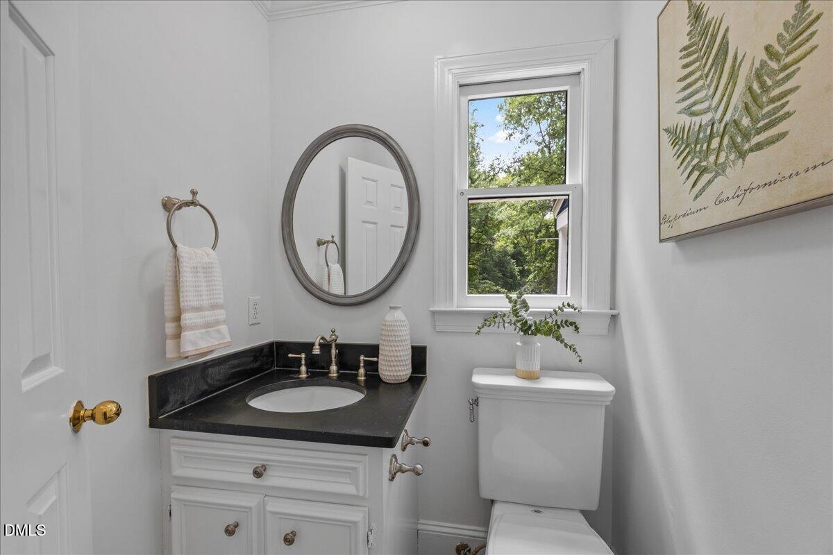6516 Bakersfield Drive Raleigh, NC 27606 - Photo 29 of 59 a bathroom with a sink and a mirror