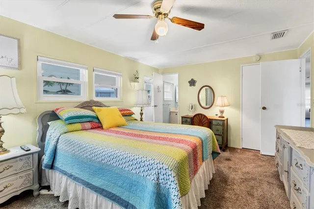 a bedroom with bed and a chandelier