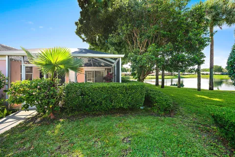 a front view of house with a garden
