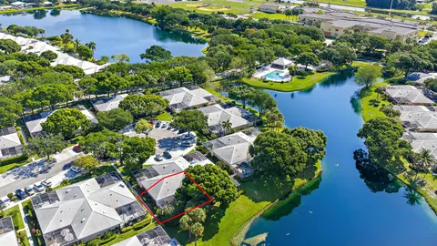 an aerial view of a house with a yard and lake view