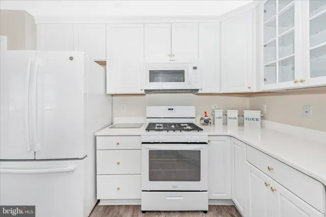 a kitchen with cabinets appliances and a sink