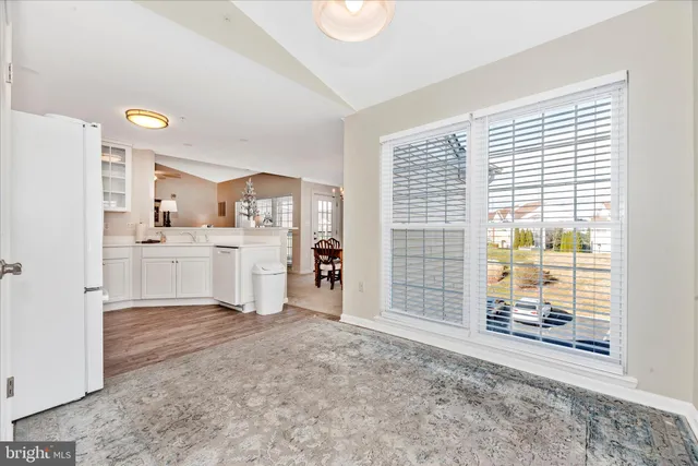 a view of a kitchen with wooden floor and a kitchen space