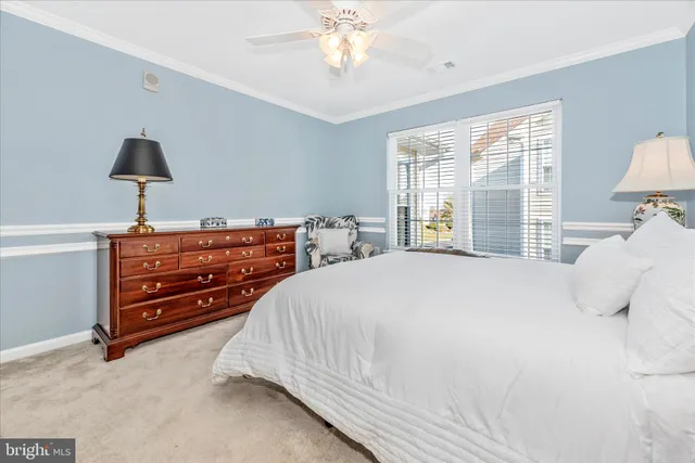 a bedroom with bed and a chandelier