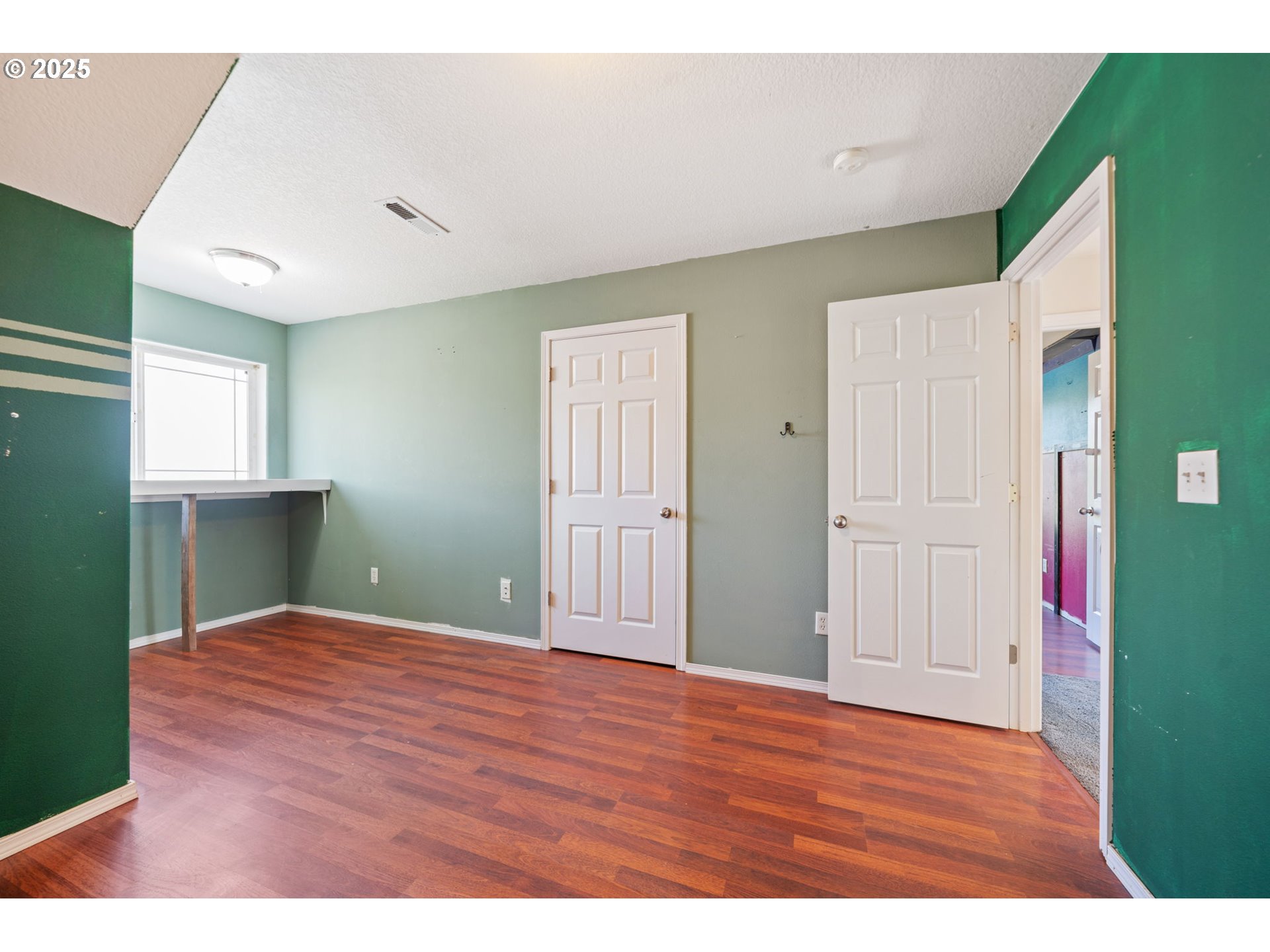 39784 Syblon Lane Sandy, OR 97055 - Photo 18 of 24 a view of an empty room with window and wooden floor