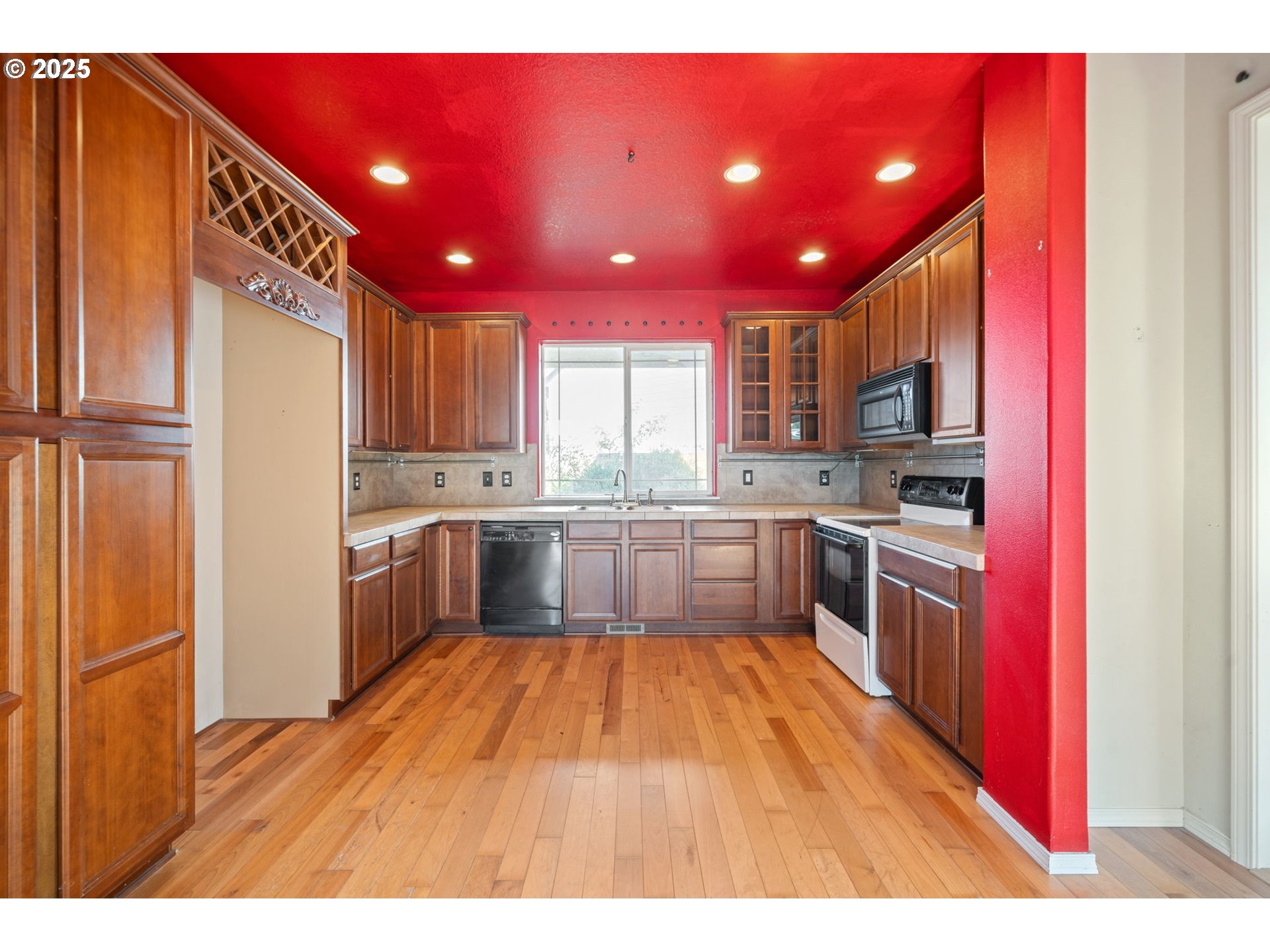 39784 Syblon Lane Sandy, OR 97055 - Photo 7 of 24 a kitchen with a refrigerator sink and cabinets