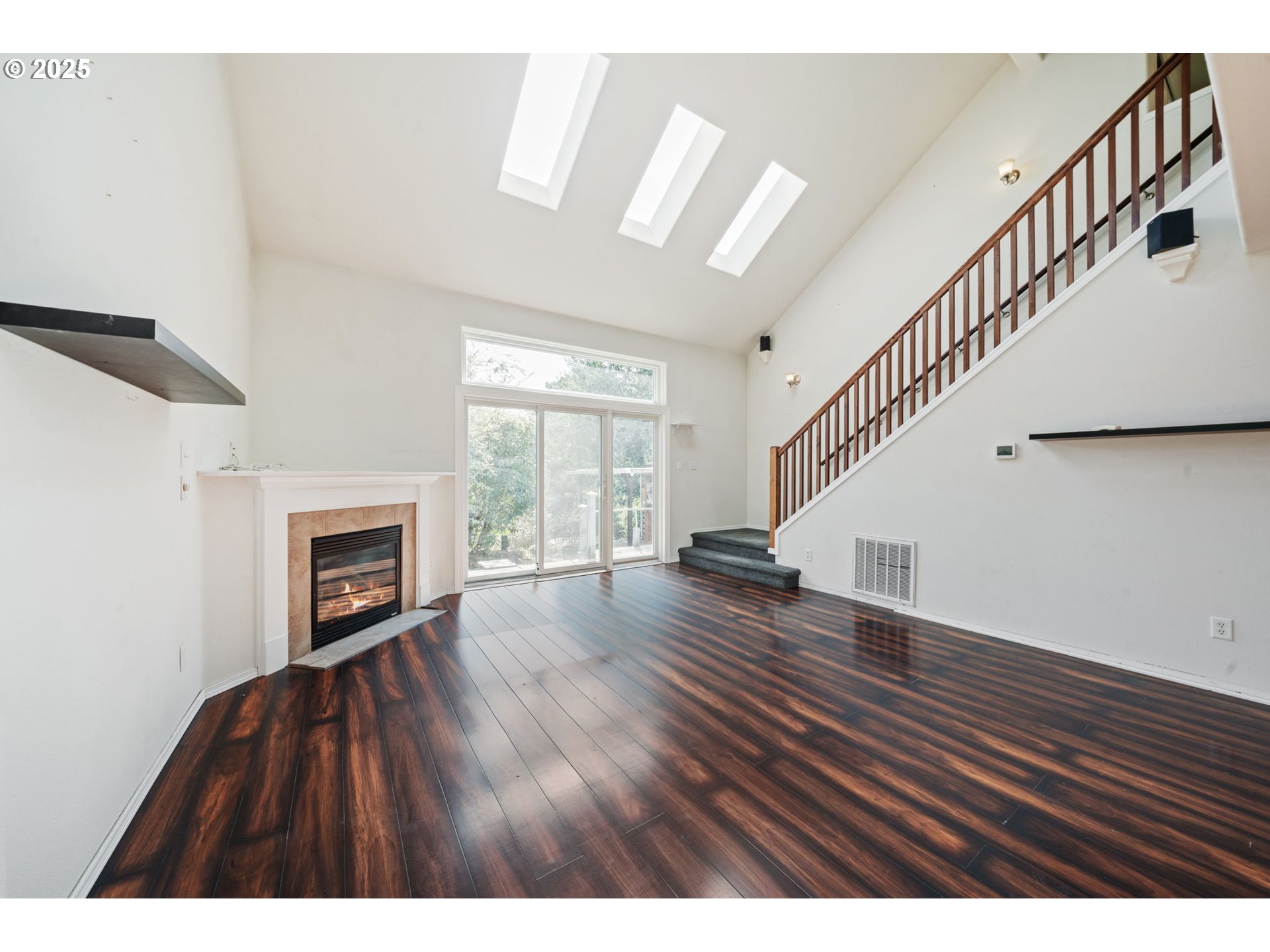 39784 Syblon Lane Sandy, OR 97055 - Photo 9 of 24 a view of an empty room with wooden floor fireplace and a window