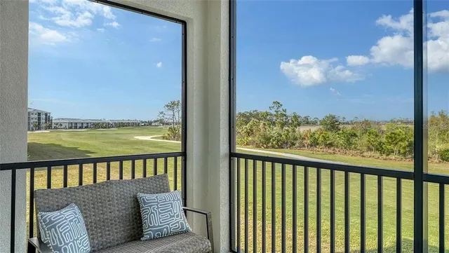 a bedroom with a bed and a lamp on dresser