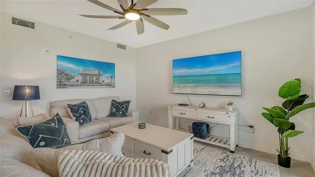 a kitchen with stainless steel appliances a table chairs refrigerator and microwave