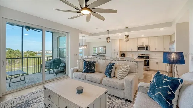 a kitchen with stainless steel appliances a white table chairs and a window