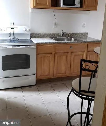 a kitchen with a stove window and cabinets
