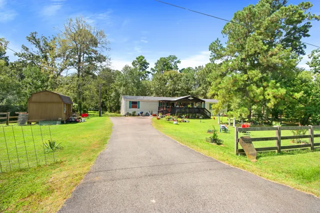 a view of park with plants and large trees
