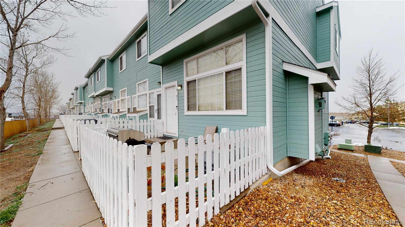 8199 Welby Road, Unit 4001 Denver, CO 80229 - Photo 1 of 24 a view of a house with wooden fence