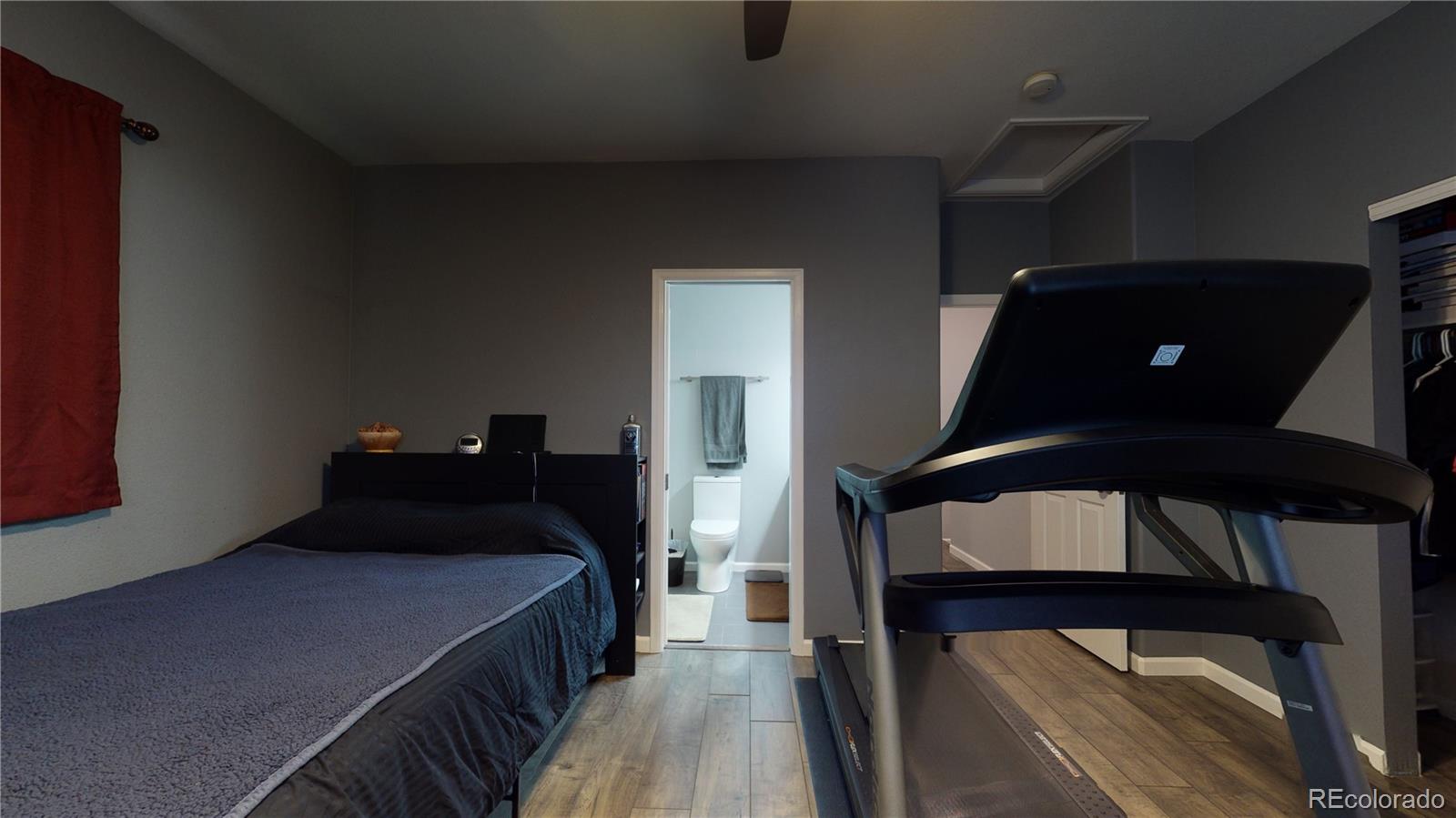 8199 Welby Road, Unit 4001 Denver, CO 80229 - Photo 13 of 24 a bedroom with a bed and wooden floor