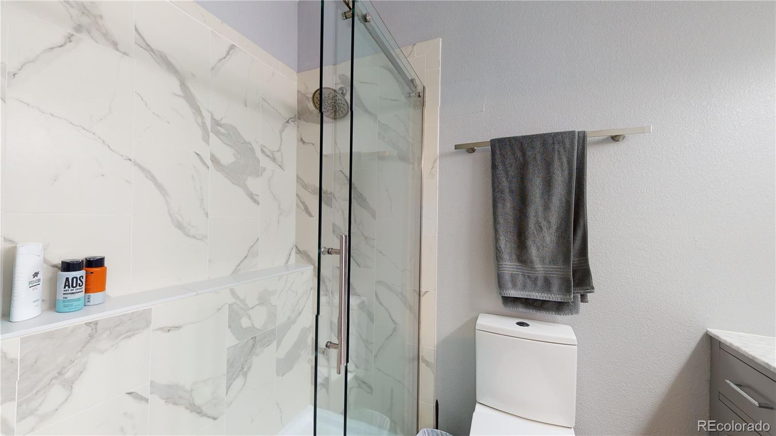 8199 Welby Road, Unit 4001 Denver, CO 80229 - Photo 14 of 24 a bathroom with a shower and a sink