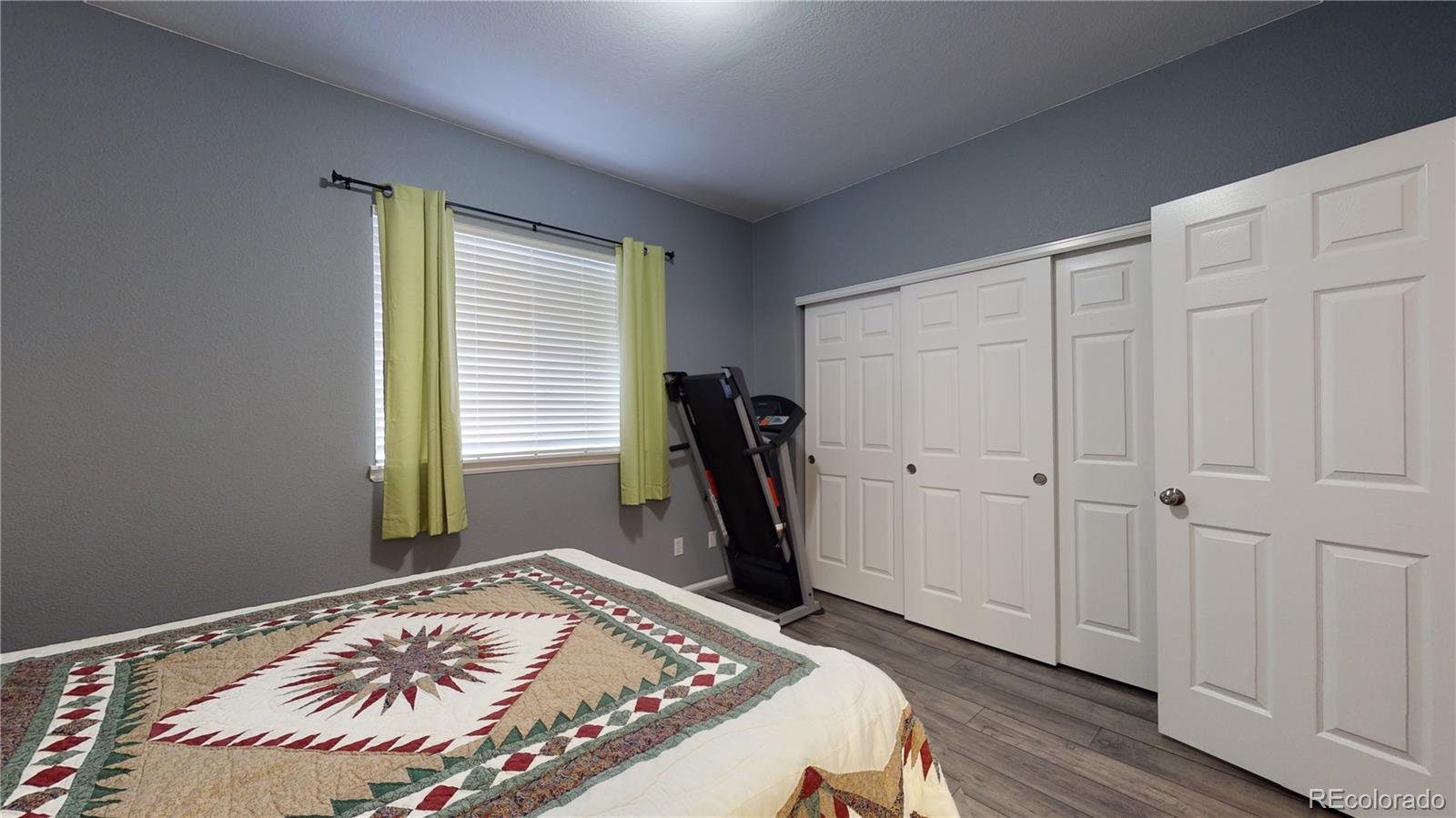 8199 Welby Road, Unit 4001 Denver, CO 80229 - Photo 17 of 24 a bedroom with a bed and a window