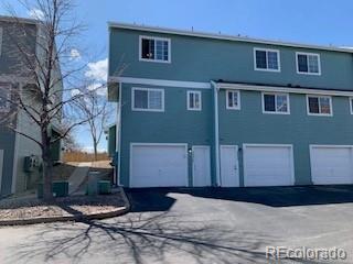 8199 Welby Road, Unit 4001 Denver, CO 80229 - Photo 23 of 24 a front view of a house with a yard