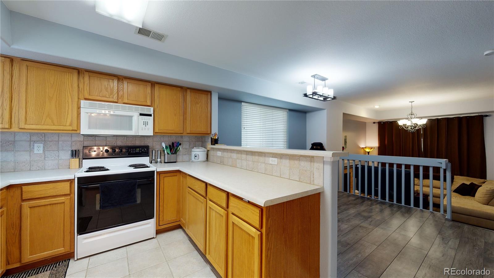 8199 Welby Road, Unit 4001 Denver, CO 80229 - Photo 9 of 24 a kitchen with stainless steel appliances granite countertop a stove and a sink