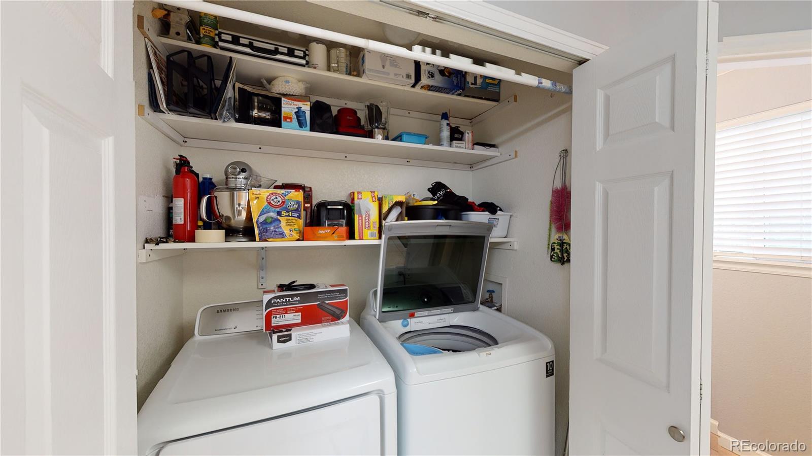 8199 Welby Road, Unit 4001 Denver, CO 80229 - Photo 10 of 24 a utility room with dryer and washer