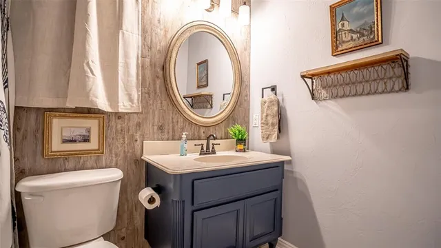 a bathroom with a sink a toilet and a mirror