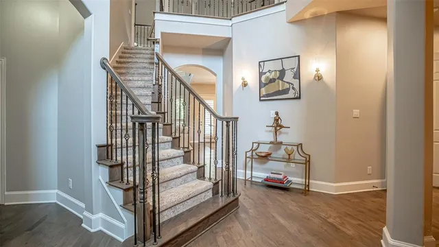 a view of a hallway to a livingroom with furniture