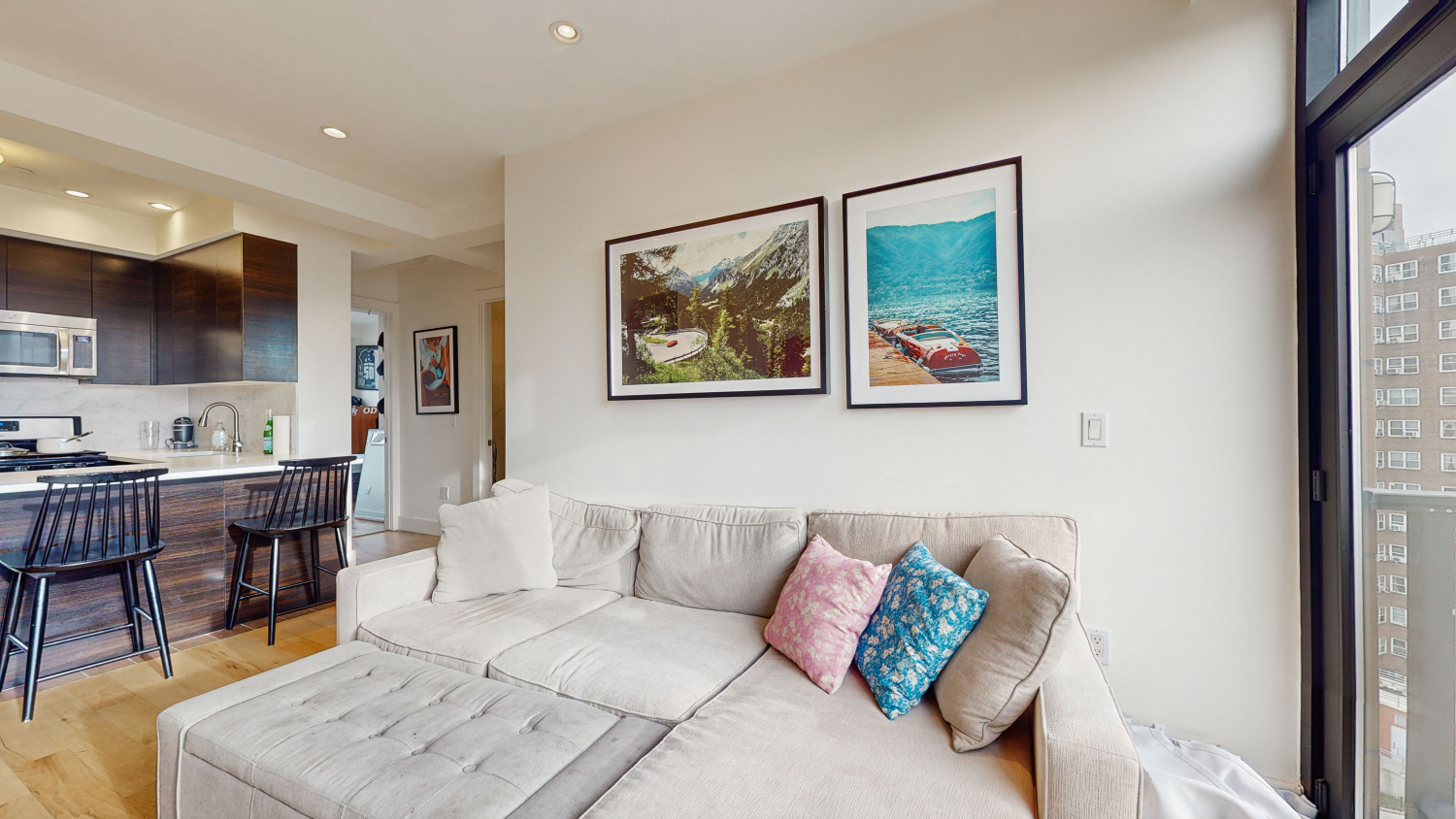 399 East 8th Street, Unit 8C Manhattan, NY 10009 - Photo 2 of 8 a living room with furniture and a view of kitchen