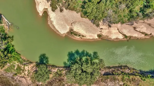 a view of a lake with a yard