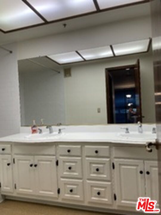 880 West 1st Street, Unit 613 Los Angeles, CA 90012 - Photo 13 of 27 a bathroom with a sink vanity and mirror