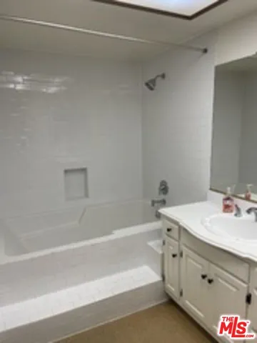a bathroom with a shower and a sink