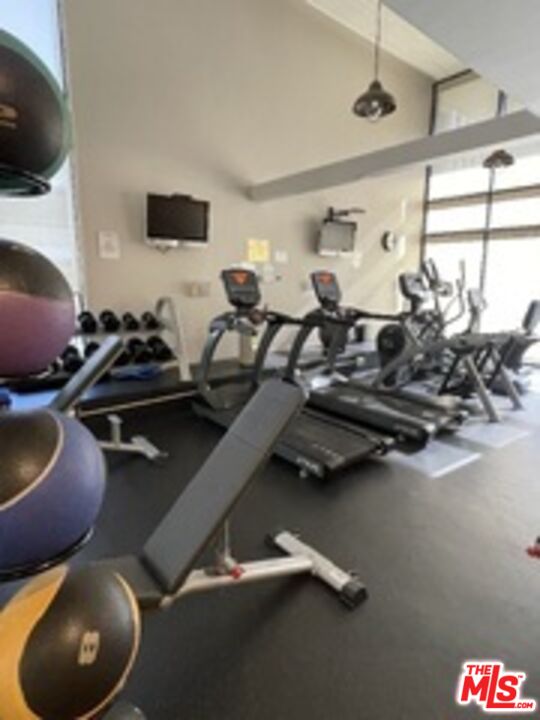 880 West 1st Street, Unit 613 Los Angeles, CA 90012 - Photo 22 of 27 a room with gym equipment and a flat screen tv