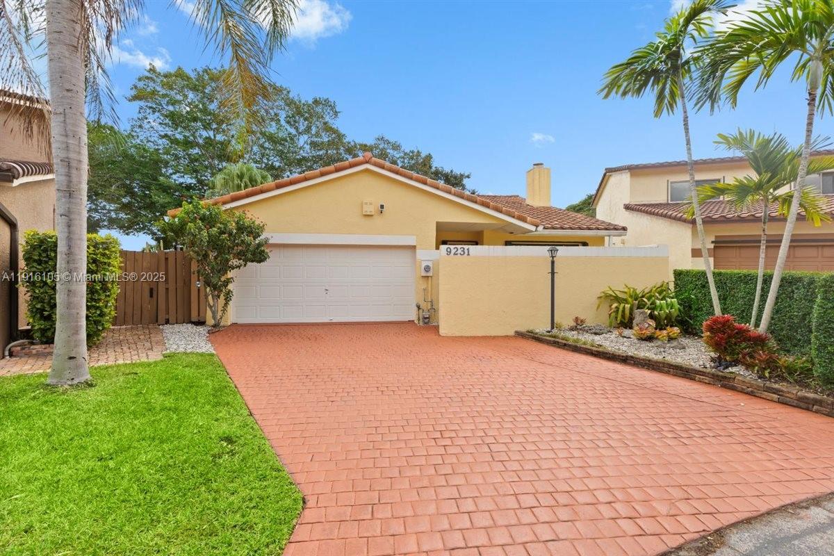 9231 Southwest 150th Avenue Miami, FL 33196 - Photo 1 of 51 a front view of a house with garden