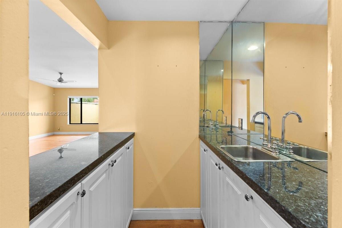 9231 Southwest 150th Avenue Miami, FL 33196 - Photo 13 of 51 a bathroom with a granite countertop sink and a large mirror