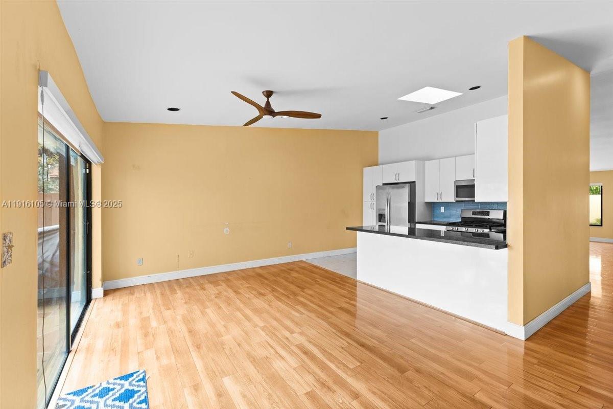 9231 Southwest 150th Avenue Miami, FL 33196 - Photo 14 of 51 a kitchen with stainless steel appliances a refrigerator and a stove top oven