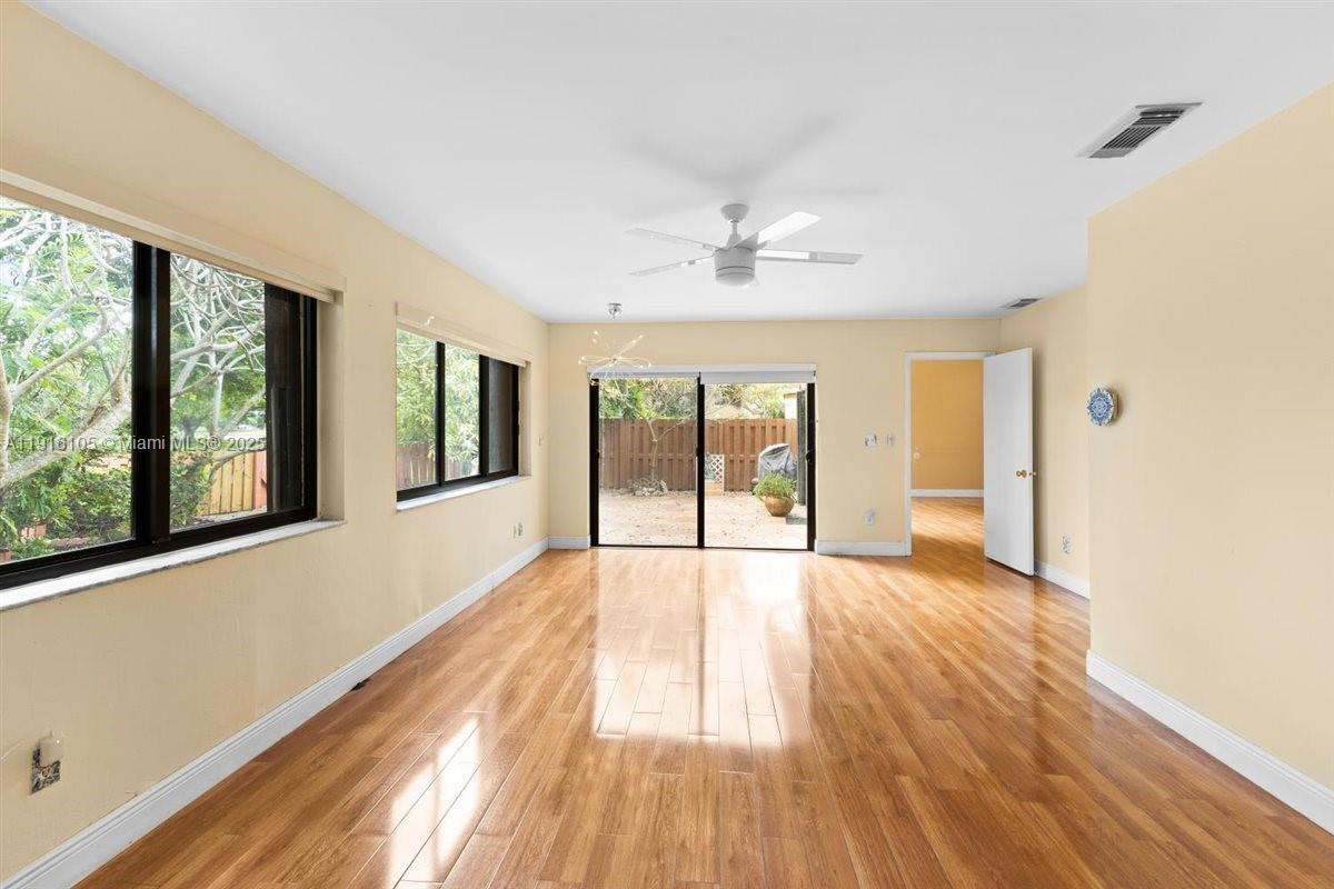 9231 Southwest 150th Avenue Miami, FL 33196 - Photo 23 of 51 a view of an empty room with a window and wooden floor