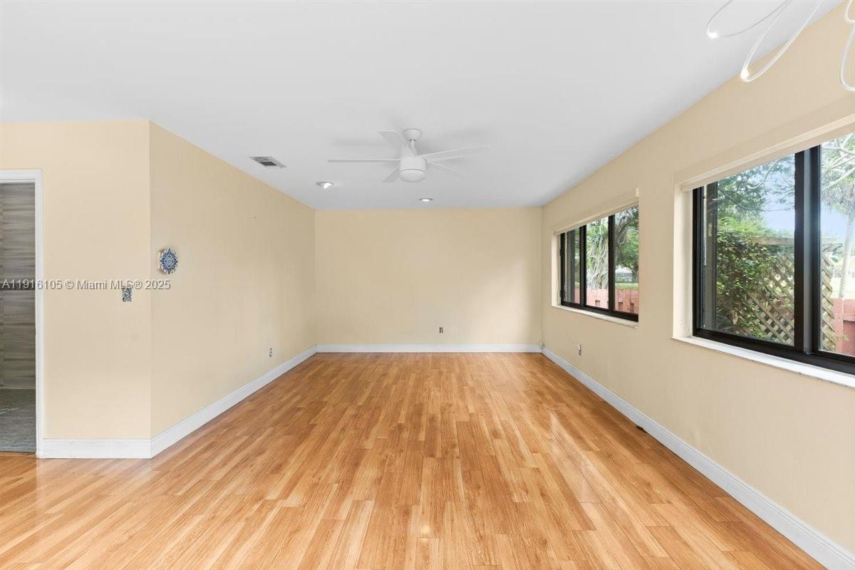 9231 Southwest 150th Avenue Miami, FL 33196 - Photo 24 of 51 a view of an empty room with wooden floor and a window