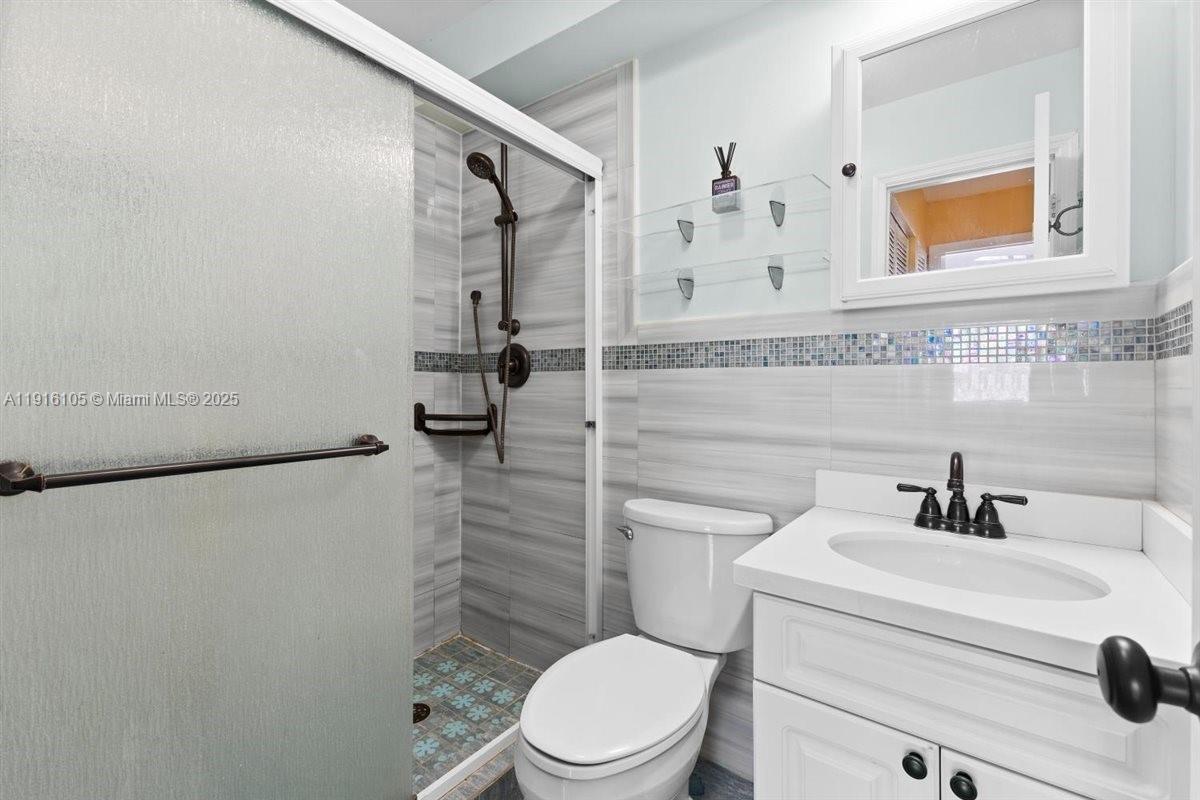 9231 Southwest 150th Avenue Miami, FL 33196 - Photo 33 of 51 a bathroom with a sink a toilet and shower
