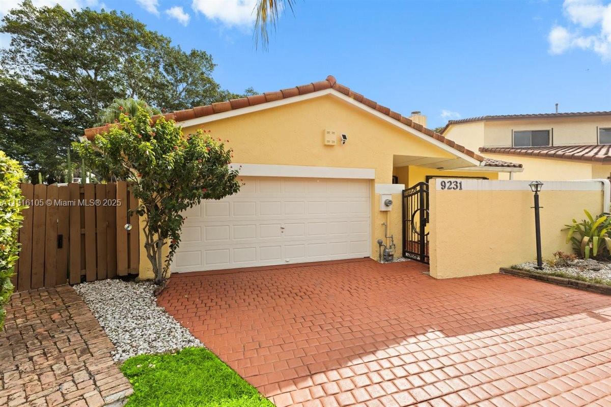 9231 Southwest 150th Avenue Miami, FL 33196 - Photo 5 of 51 a view of a garage with a tree