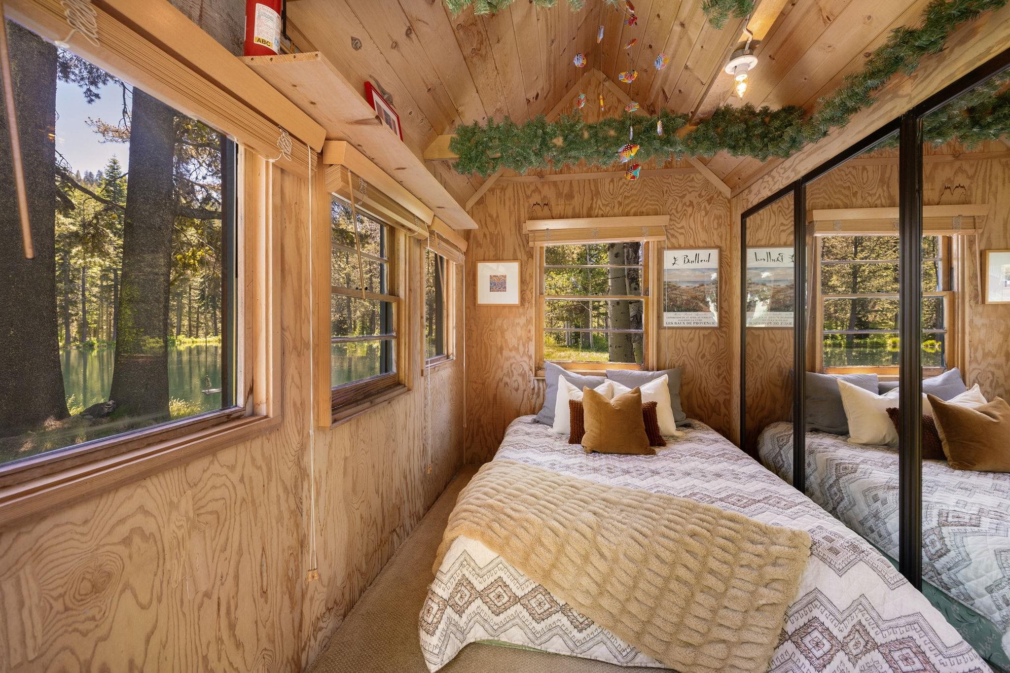 40600 Highway 49 Calpine, CA 96124 - Photo 27 of 28 a bedroom with a large bed and a large window