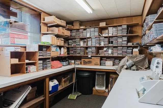 a room with stainless steel appliances kitchen island granite countertop a sink and cabinets