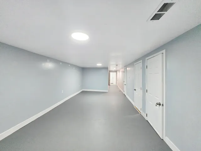 an empty room with a empty space and windows