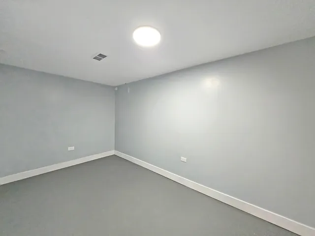 an empty room with a empty space and window