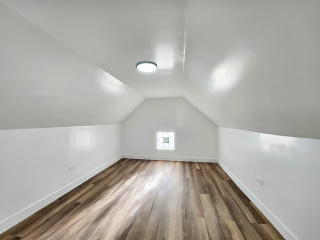 a view of room with window and hardwood floor