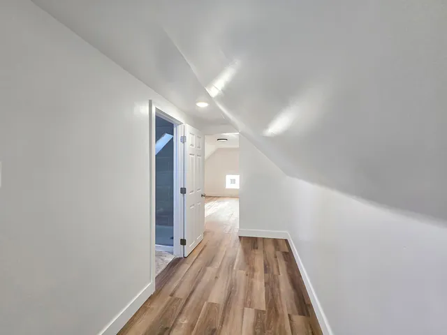 a view of a hallway with wooden floor