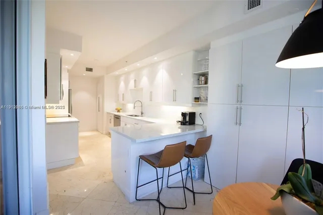 a kitchen with stainless steel appliances kitchen island granite countertop a sink and cabinets